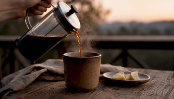 Pouring low acid coffee into ceramic cup
