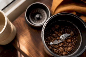 Close-up of coffee grinder mechanisms and beans