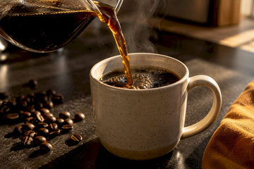Freshly brewed coffee beside roasted beans