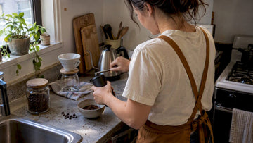 Home brewer grinding fresh coffee beans