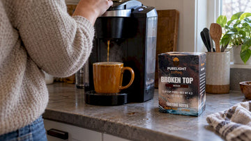 Broken Top coffee pod beside brewing cup