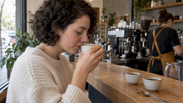 Customer tasting coffee at a neighborhood bar